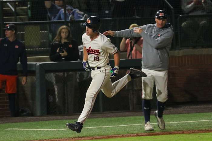 Ike Irish rounds third after hitting a home run for Auburn baseball against Alabama.